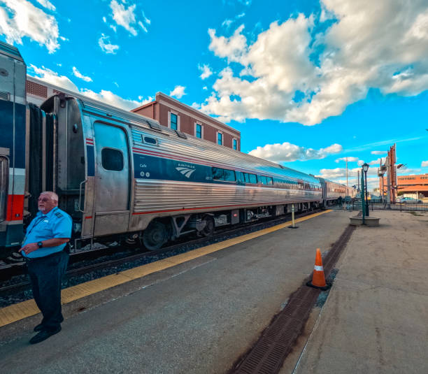 Amtrak Train Stops at the Train Station Springfield, Illinois, USA, October 7, 2023, Amtrak train stopped on the train tracks awaiting passengers to board. Train conductor stands next to the train to assist passengers boarding. Amtrak stock pictures, royalty-free photos & images