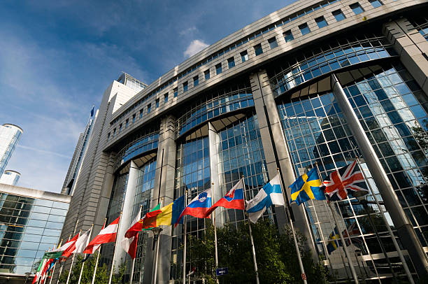 The European Parliament in Brussels with flags outside stock photo