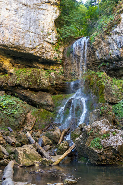 istock Autumn waterfall in early autumn in the forest. Landscape with a waterfall 1735547982