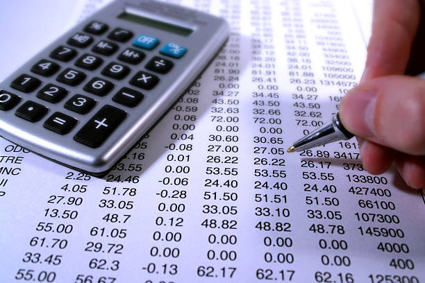 Going Over The Numbers Checking out numbers on a balance sheet. Soft focus on background. cash flow projections stock pictures, royalty-free photos & images