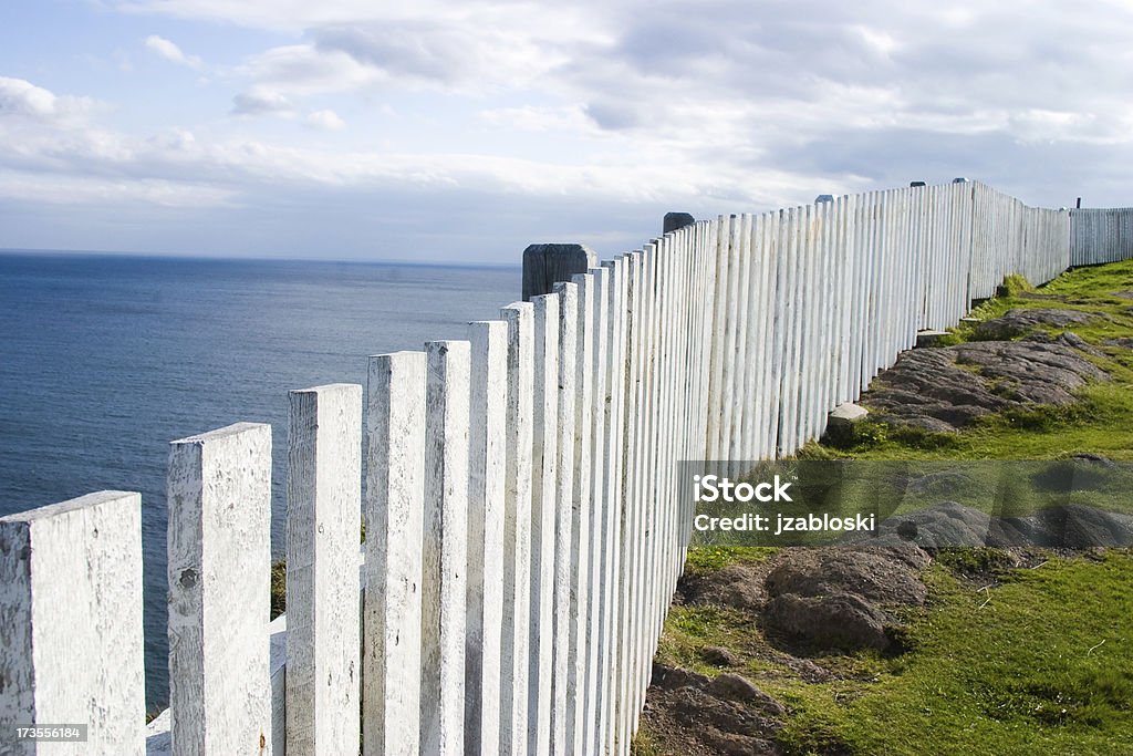 The dividing line fence at the cape spear lighthouse. At The Edge Of Stock Photo