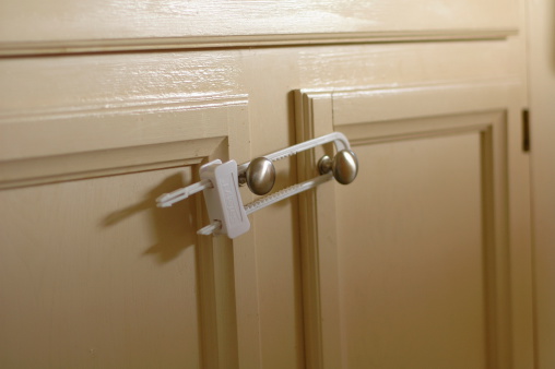 Modern black door handle on white wooden door in interior. Knob close-up elements. Door handle, fittings for interior design