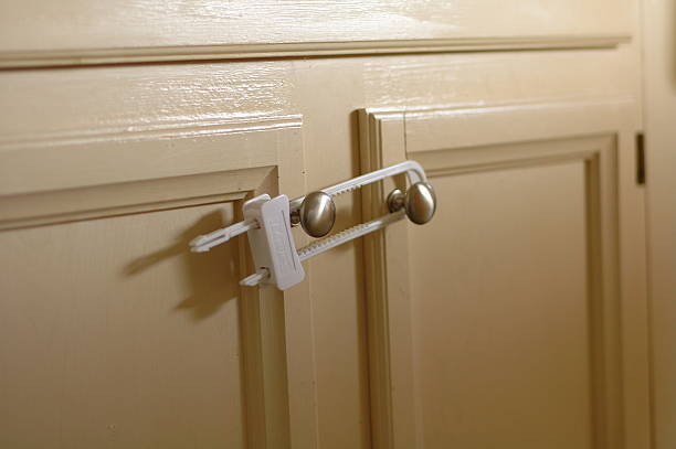 Child Safety Cabinet A child safety device securing cabinet doors from being opened. latch photos stock pictures, royalty-free photos & images