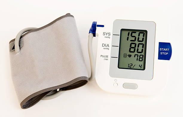 Monitor with cuff showing stage 1 hypertension or high blood pressure