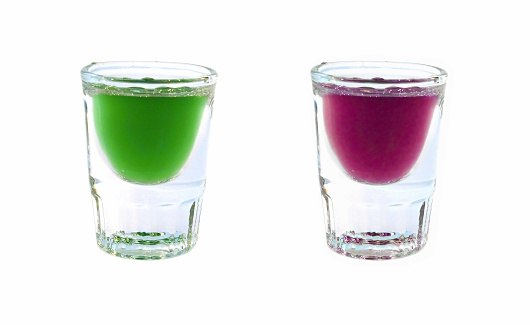 Two shot glasses with purple and green alchohol.Similar Images: