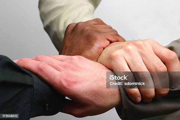 Teaming Up Stock Photo - Download Image Now - Three People, Handshake, Multiracial Group