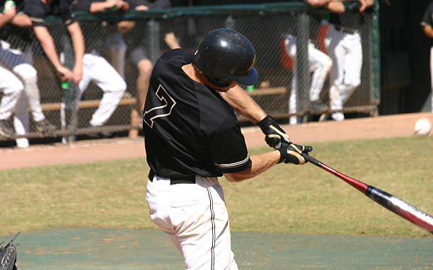 istock Baseball player swinging bat on baseball field 173558616
