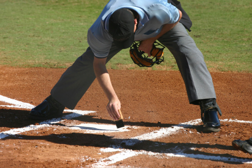 Baseball base or plat white against a dark dirt for competition and playing game