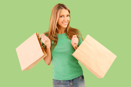 Woman with paper bags on green background