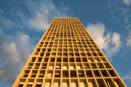 A condominium tower as seen from below.