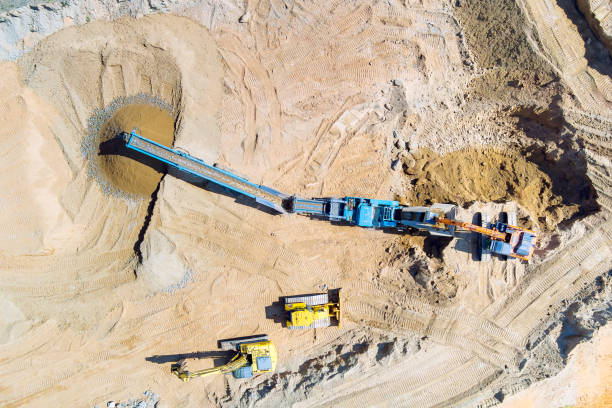 istock Gravel quarry mining with a cone rock crusher for processing crushed granite 1735604324