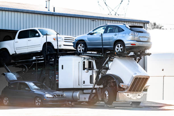 istock Loaded big rig car hauler semi truck with open hood trying to fix a broken engine while standing in the parking lot of a repair shop 1735605572