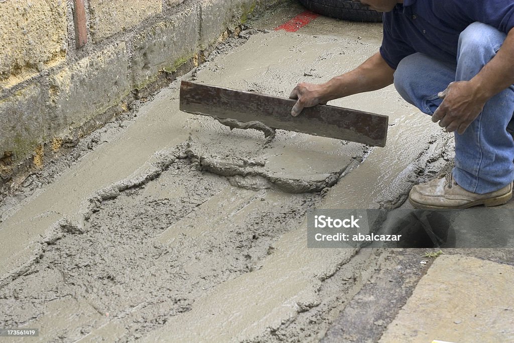 leveling hispanic worker molding concrete Latin American and Hispanic Ethnicity Stock Photo