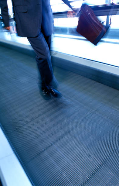 istock businessman on moving walkway 173562542