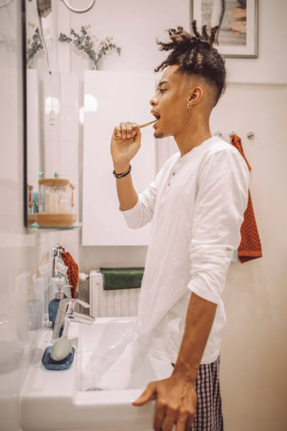 istock At home - young man brushing his teeth 1735626796