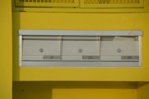 The metal post box with a secure lock is placed outdoors to ensure the safety of mail and packages