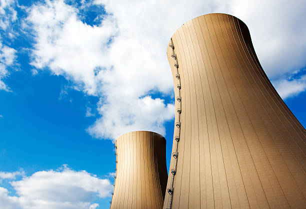 istock Nuclear power plant against blue sky and clouds 173563627