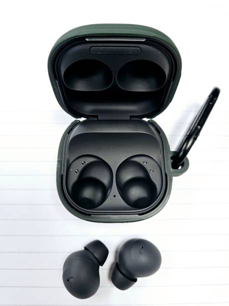 istock Closeup of black wireless earbuds on a white background 1735647816