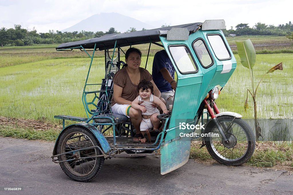 Motorcycle taxi Taxi in the Philippines. Although strictly this is a motorbike and elaborate sidecar, these are known throughout the country as 'tricycles'. Location is Bula, province of Camarines Sur, region of Bicol, island of Luzon, Phillipines. Philippines Stock Photo