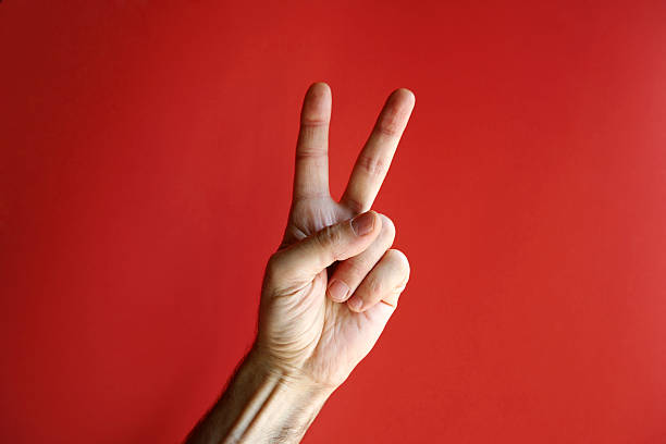 Victory or peace hand sign Raised male hand showing the victory sign. See also peace sign gesture photos stock pictures, royalty-free photos & images
