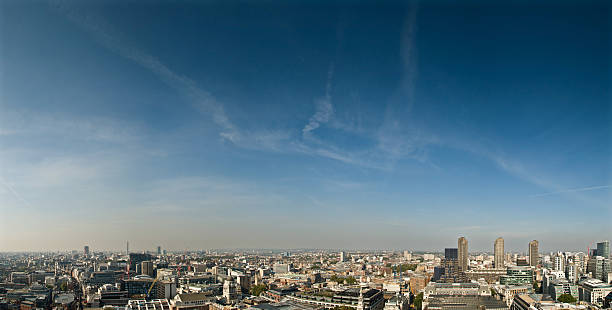 Color image depicting old Victorian architecture in central London, UK, with the imposing and futuristic Walkie Talkie building (20 Fenchurch Street) looming large in the background.