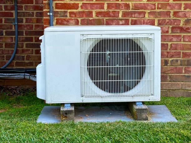 istock Heat pump outdoor unit against brick wall 1735679381