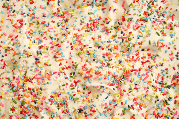 Sprinkles and cream Closeup view of cake topping made out of cream and sprinkles abundance stock pictures, royalty-free photos & images