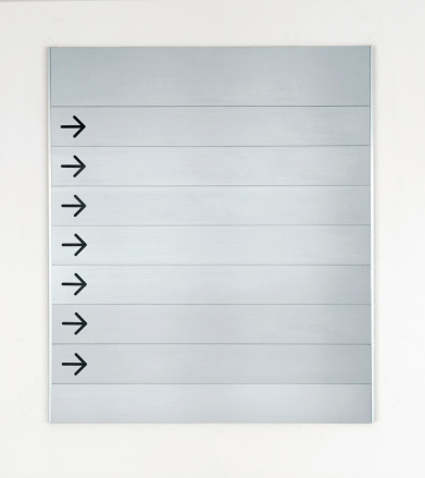 Blank interior brushed metal directions sign.