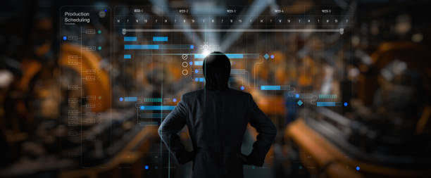 Back view of Engineer manager working with Ai computer virtual on The robotics schedule production plant is working on time.