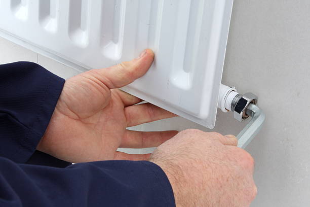 istock Close-up of a man doing repair work on a radiator 173568791