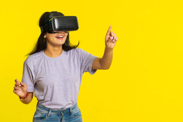 istock Excited woman in VR headset helmet watching virtual reality 3D video, playing simulation online game 1735692602