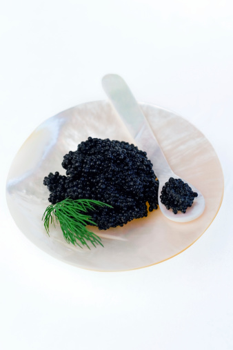 Caviar served on a hand carved mother of pearl dish.  Shallow dof