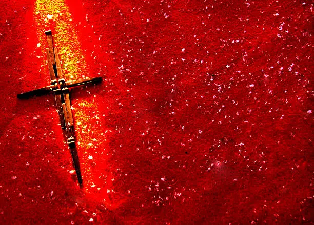 Cross of nails on a red background