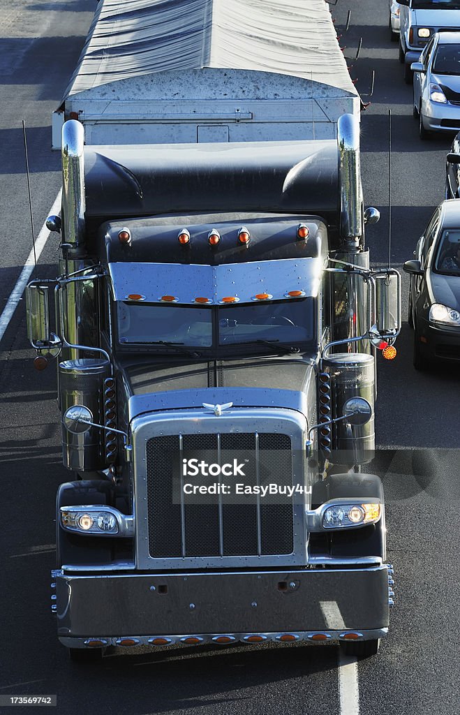 Semi truck Black semi truck changing lane in traffic. Check my transportation lightbox for more trucks. Black Color Stock Photo