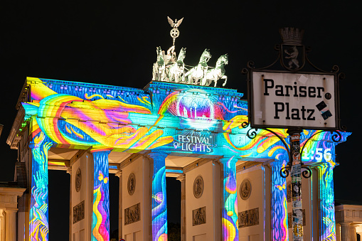 Germany, Berlin, October 11, 2023 - Berlin Brandenburg gate with street sign Pariser Platz at Festival of Lights - Berlin