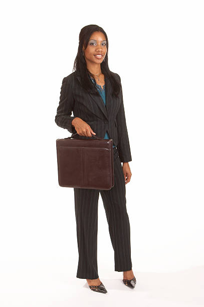 A black American Businesswoman carries her portfolio to the office.