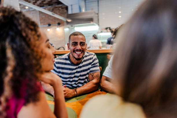 istock Young man talking with friends at restaurant 1735711078