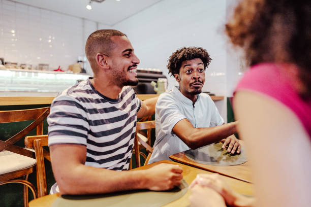 istock Young men talking with friends at restaurant 1735711082