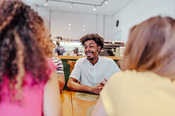 istock Young man talking with friends at restaurant 1735711084