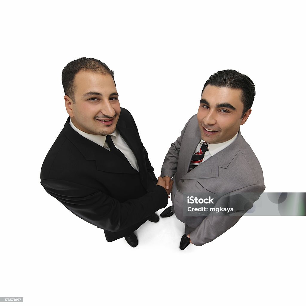 Business Handshake "Two businessmen standing and shaking hands, isolated on white background.Wide-angle lens used." Men Stock Photo