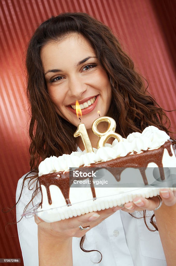 Girl holding Birthday Cake with Candles 18th Closeup of beautiful smiling girl holding Birthday Cake with number 18 candles 18-19 Years Stock Photo