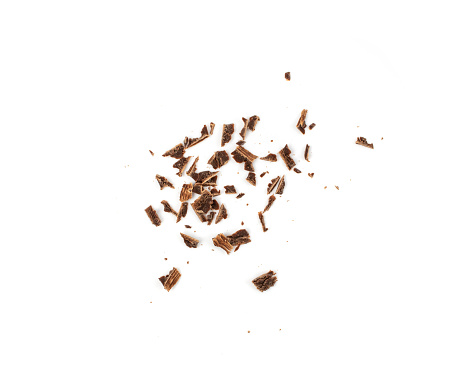 Grated chocolate pile isolated. Crushed chocolate shavings, crumbs, flakes heap, cocoa sprinkles for desserts decoration on white background top view
