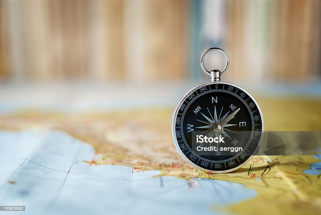 compass on the map compass on the map and book in the background in the area of confusion Brown Stock Photo