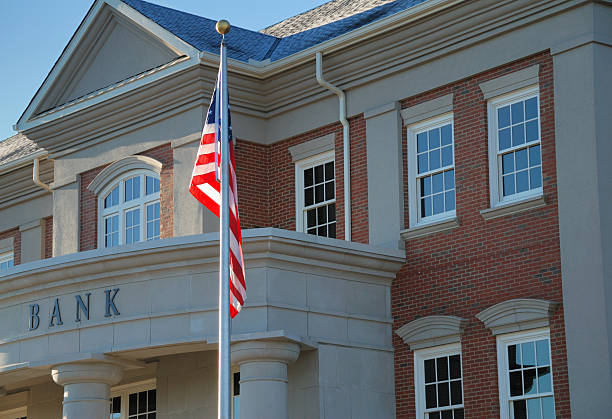 Outside view of a bank with American flag stock photo