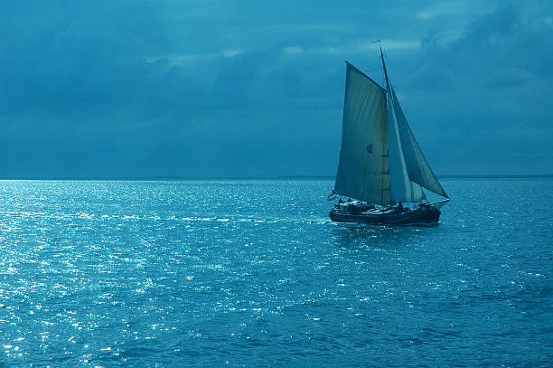 istock Tallship at night with moonlight reflecting 2 173573426