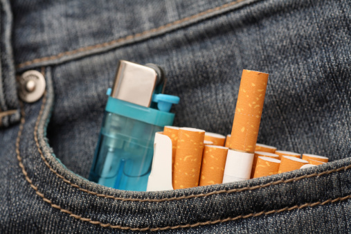 Pack of cigarettes and lighter in pocket of jeans. Close-up.Please see lightbox: