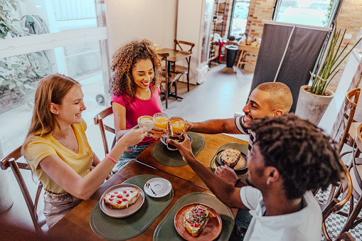 Friends toasting at coffee shop