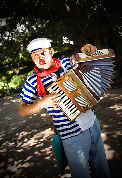 istock Funny sailor clown with piano accordion 173574200