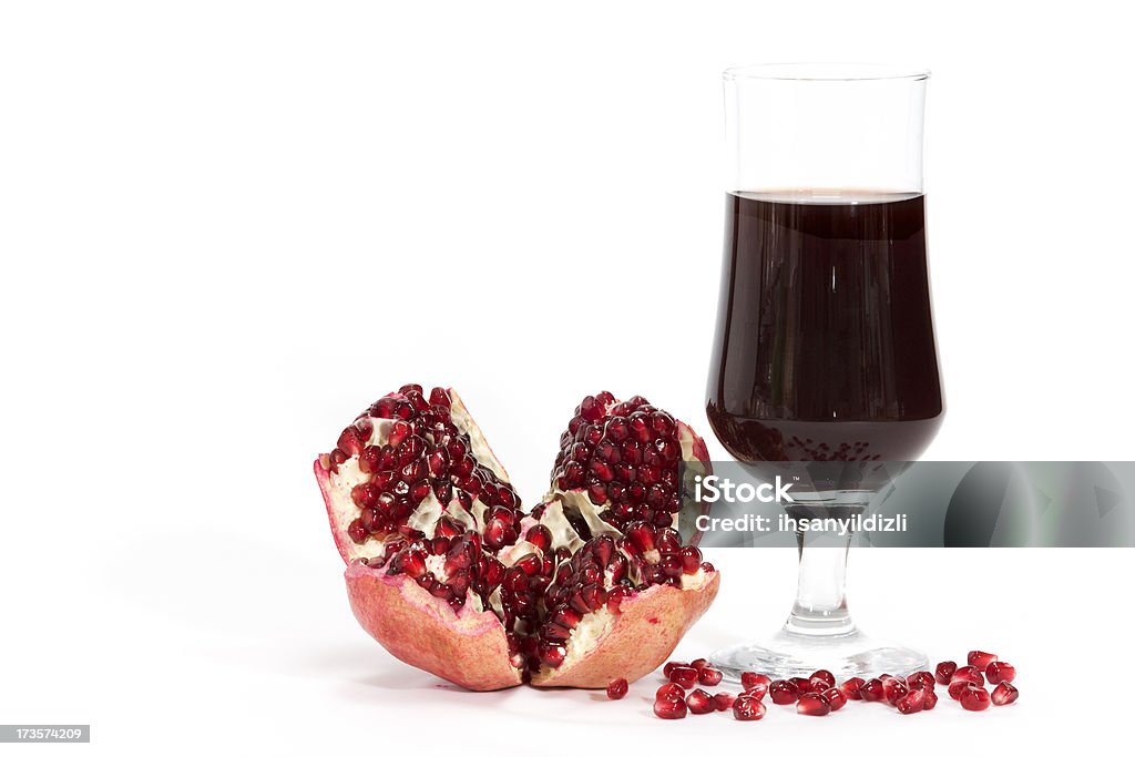 Pomegranate Pomegranate fruit and a glass of its juice on white background. Antioxidant Stock Photo