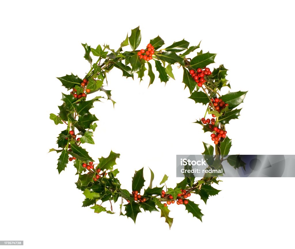 Green holly wreath with red berries wreath made of fresh holly with red berries on white background. Christmas Stock Photo